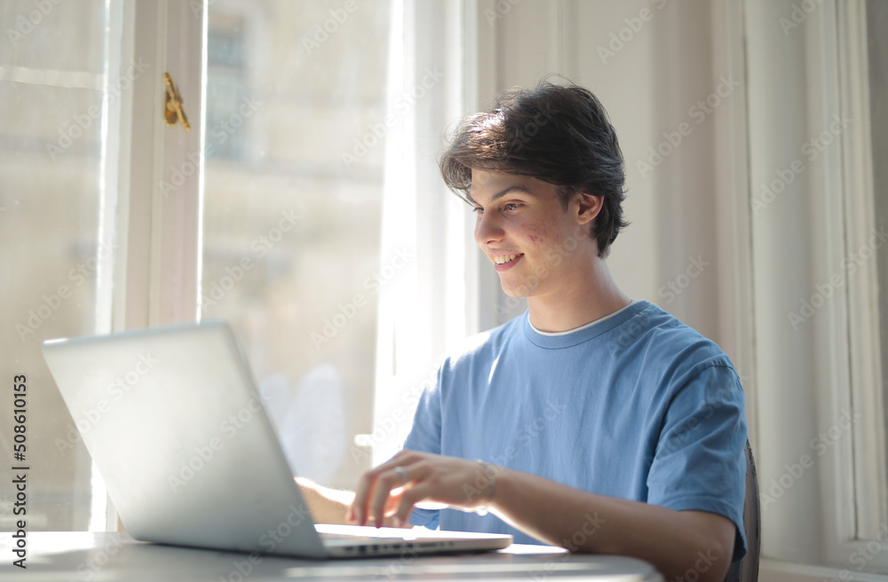 young man works with a computer young man works with a computer