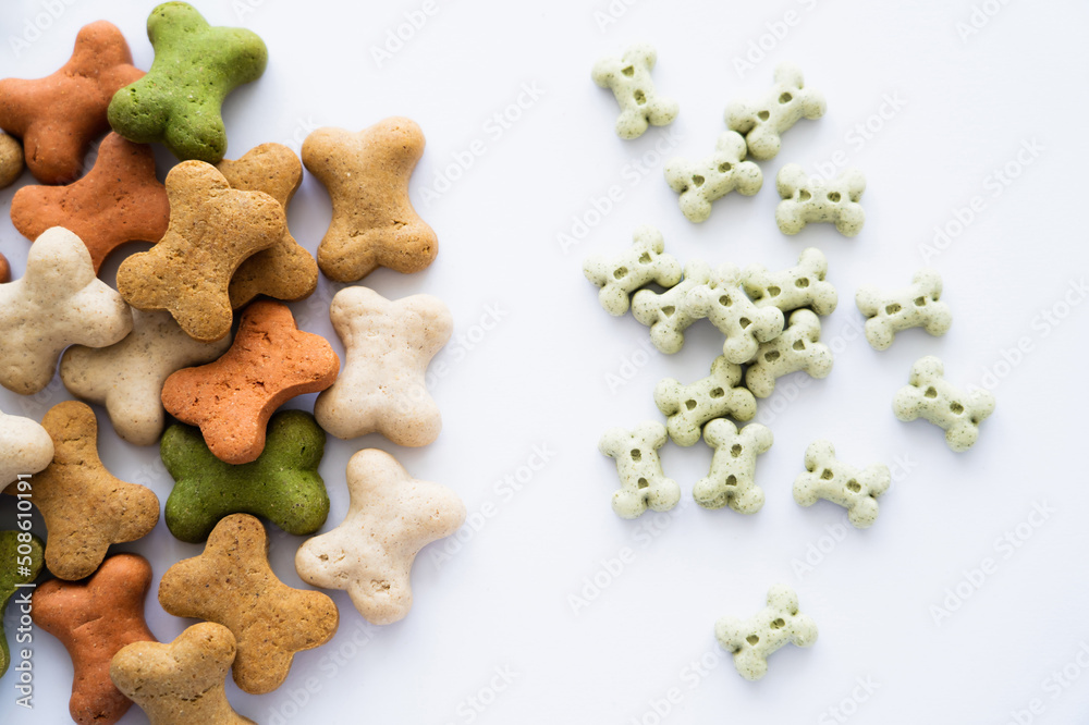 Fototapeta premium top view of tasty bone shaped cookies for dog isolated on white.