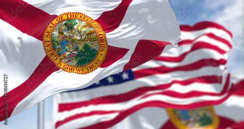 The Florida state flag waving along with the national flag of the United States of America