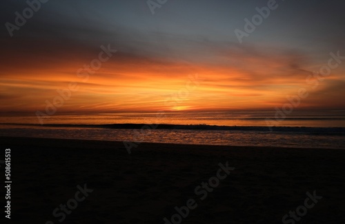 Orange sunset at the ocean  empty beach  evening time