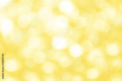 Defocused bright abstract yellow holiday background with shimmering sunspots. Bokeh. Holiday concept. Copy space for text.