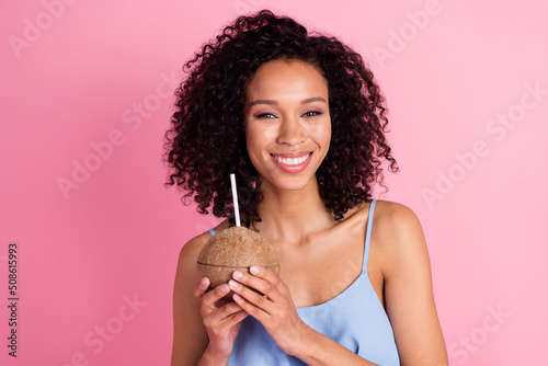 Photo of gorgeous friendly person hold coconut drink milk toothy smile isolated on pink color background