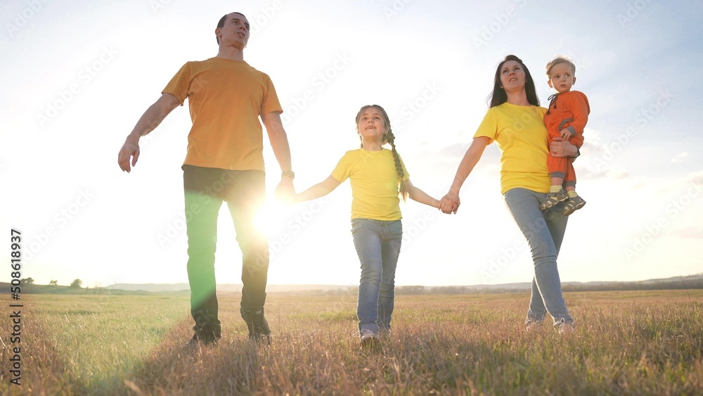 people in the park. happy family a silhouette walk at sunset. mom dad and daughters walk holding hands in park. happy family kid dream concept. parents and fun children walking fun back silhouette people in the park. happy family a silhouette walk at sunset. mom dad and daughters walk holding hands in park. happy family kid dream concept. parents and fun children walking fun back silhouette