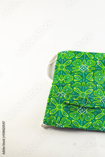 corner and the rubber band of the batik mask on an isolated white background. green color. copy space of health, guards, fashion and clothing accessories.