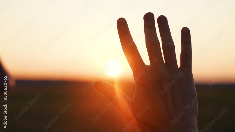 man hand silhouette sunlight. Muslim with man hand sun on light background. christian business love religion concept. christianity and religion belief in god. man sunlight hand reaches for sun god