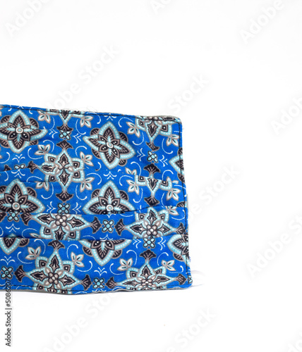 protective mask from the corona virus with beautiful batik motif on an isolated white background. green color. copy space of health, guards, fashion and clothing accessories.