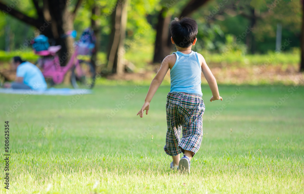 An asian boy playing outdoor activity with excited on something new,