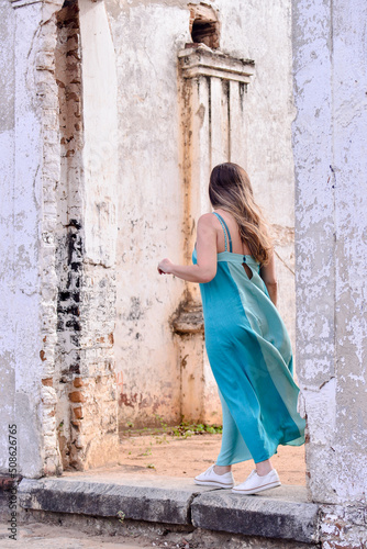woman in front of a dilapidated church  © liligluck