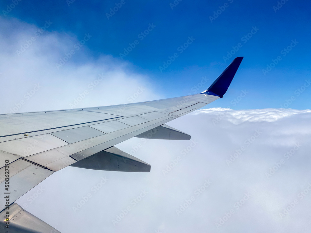 Clouds and airplane wing view from the plane window Clouds and airplane wing view from the plane window