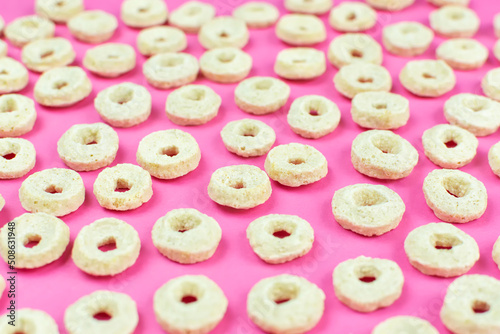 Background (texture) of oatmeal (corn) dry rings close-up. Quick healthy breakfast, add milk. Pattern.