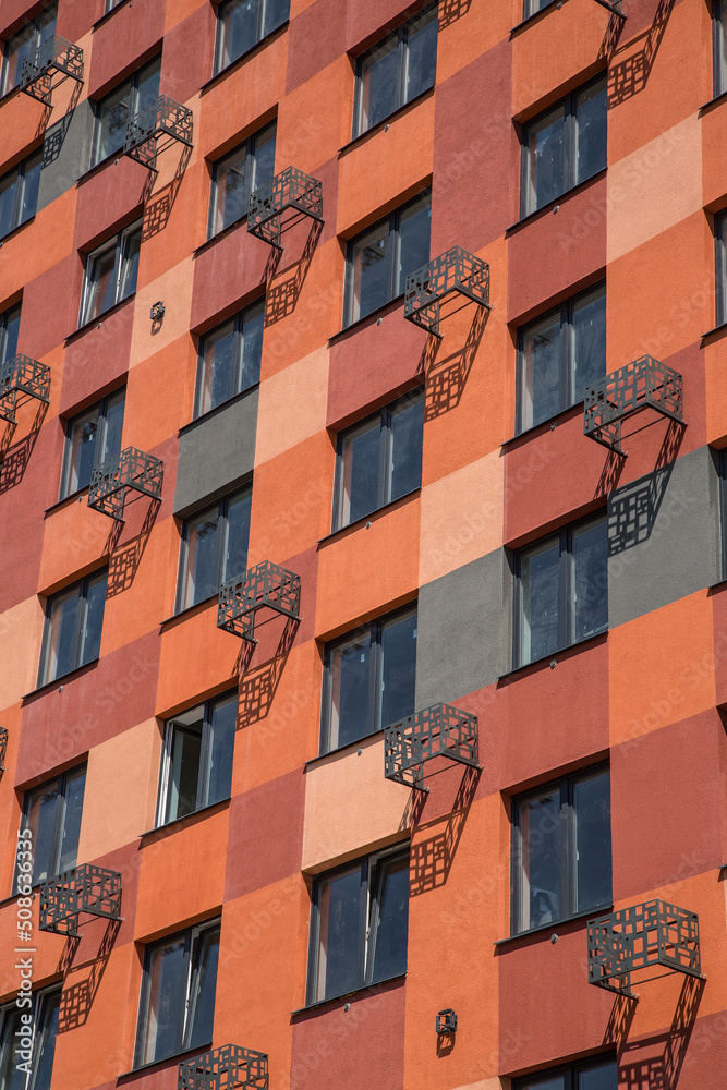 Wall section of a new uninhabited residential building in terracotta color with elements for installing outdoor domestic air conditioners