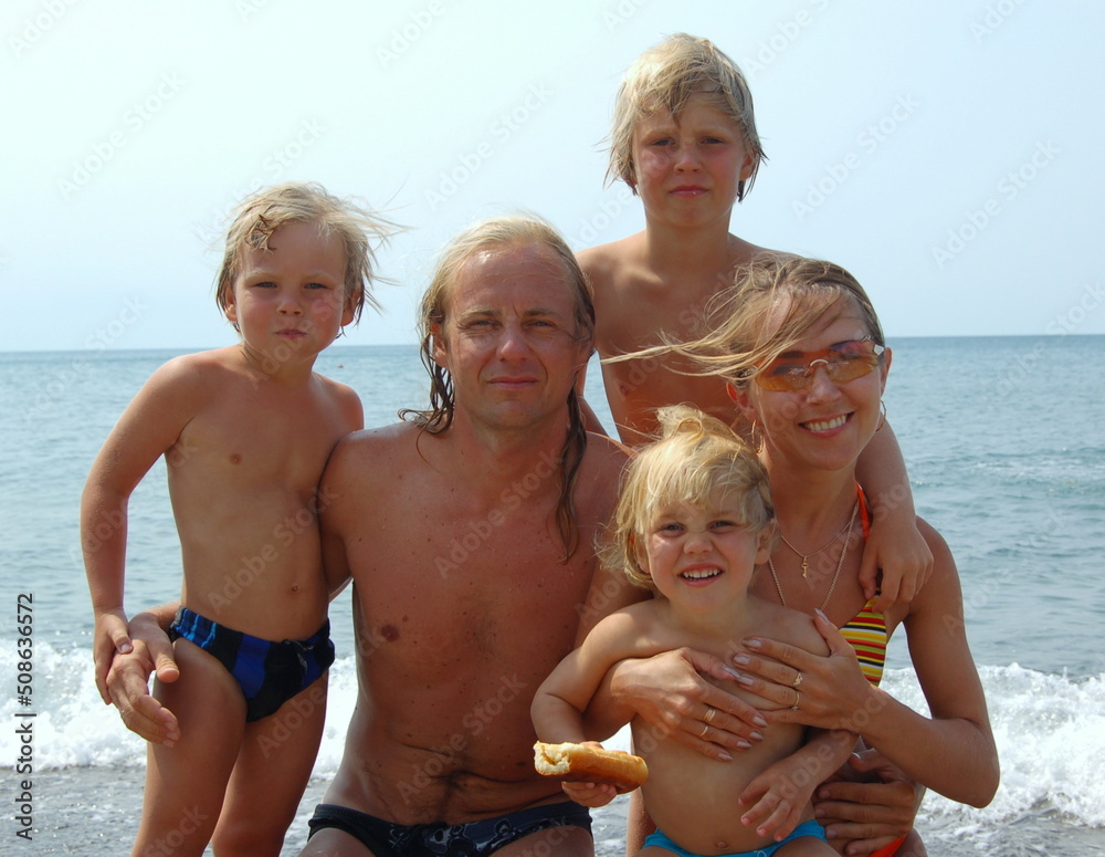 family having fun on the beach