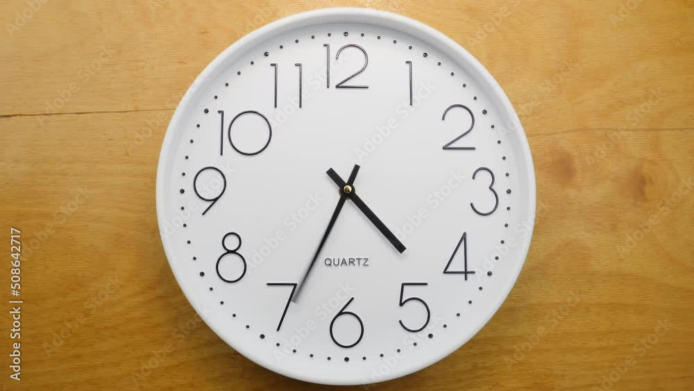 Wall clock on wooden wall. Clock hands running fast. Seamless loop Wall clock on wooden wall. Clock hands running fast. Seamless loop