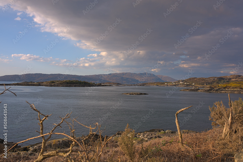 lake and mountains with dramatic clouds
