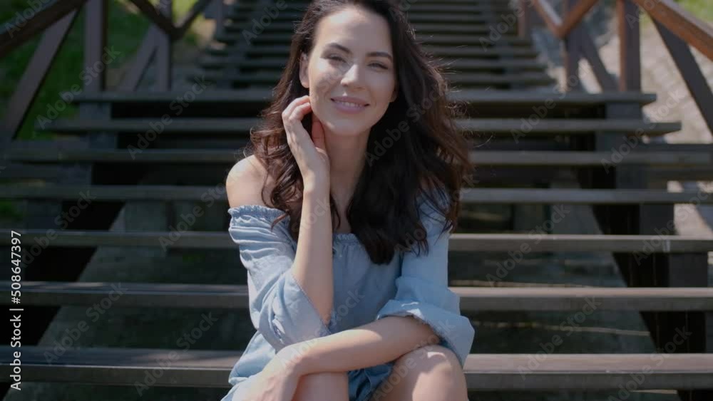 Adorable brunette woman sitting on stairs in outdoor Adorable brunette woman sitting on stairs in outdoor
