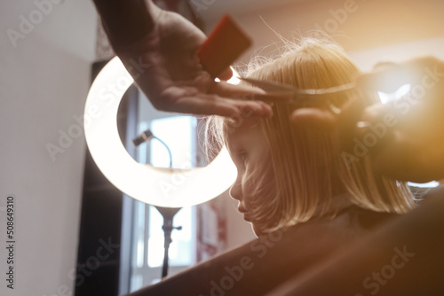 Fotobehang Barber woman make fashionable pretty hairstyle for cute little girl