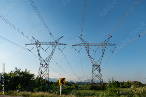 high voltage pole and has overhead power lines to bring energy into the village