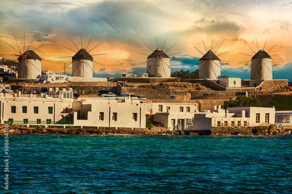 Traditional greek windmills of Mykonos island over sunset. Greece, Cyclades