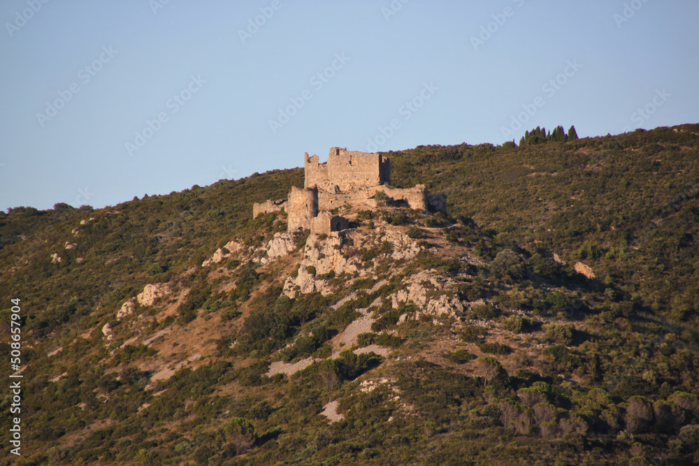 Mountain with the ruins of the medieval Aguilar Castle near Tuchan in the evening, Occitanie region in France