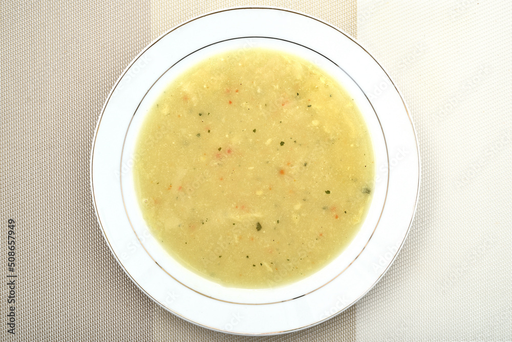 Homemade chicken cream soup with a lot of different spices in the white plate. Top view. Healthy diet concept. Homemade chicken cream soup with a lot of different spices in the white plate. Top view. Healthy diet concept.