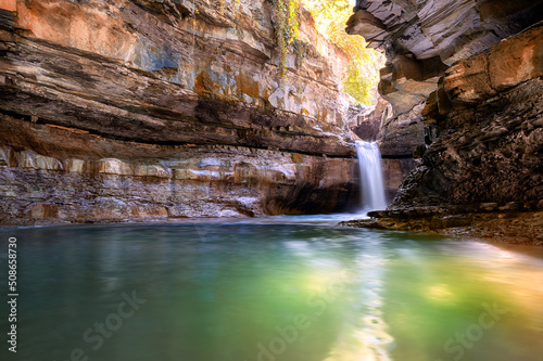 Italy  2 June 2022. Wonderful waterfall in Premilcuore surrounded by nature with rocks  in long exposure.