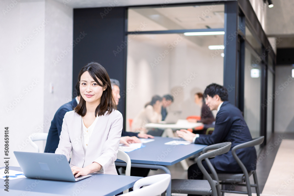 A career woman working at her desk in a shared office