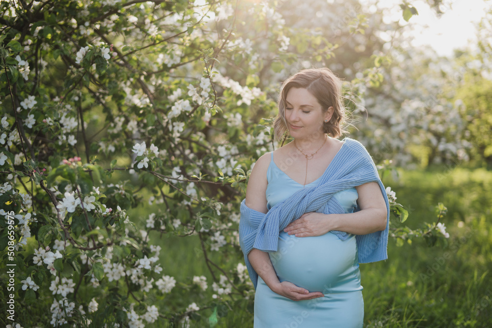 Middle-aged beautiful pregnant woman dreaming about child outdoors. Happy expectant thinking about baby and enjoying her future life. Motherhood, pregnancy, happiness, health care concept, copy space. Middle-aged beautiful pregnant woman dreaming about child outdoors. Happy expectant thinking about baby and enjoying her future life. Motherhood, pregnancy, happiness, health care concept, copy space.