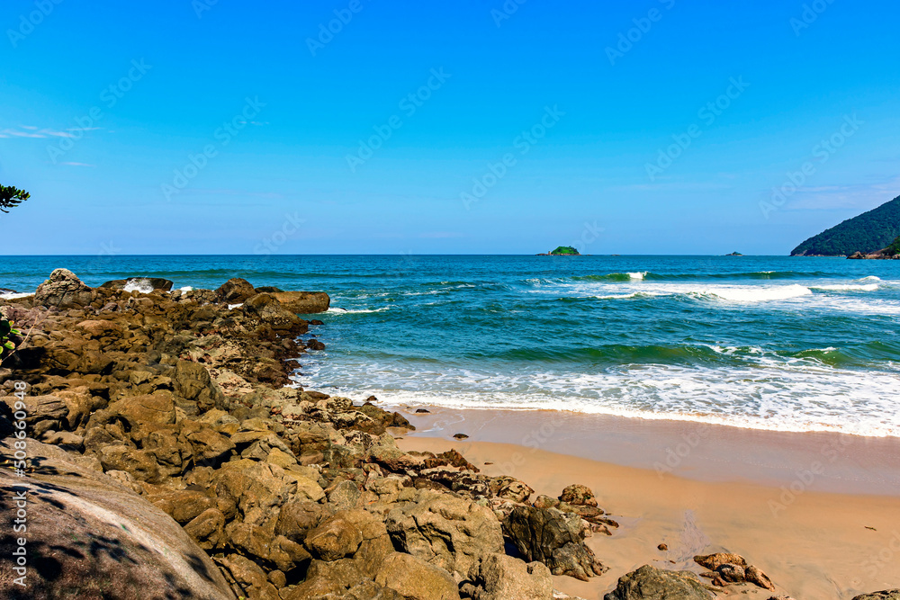 Paradisiacal rocky beach with clean and calm waters in Bertioga coastal state of Sao Paulo, Brazil