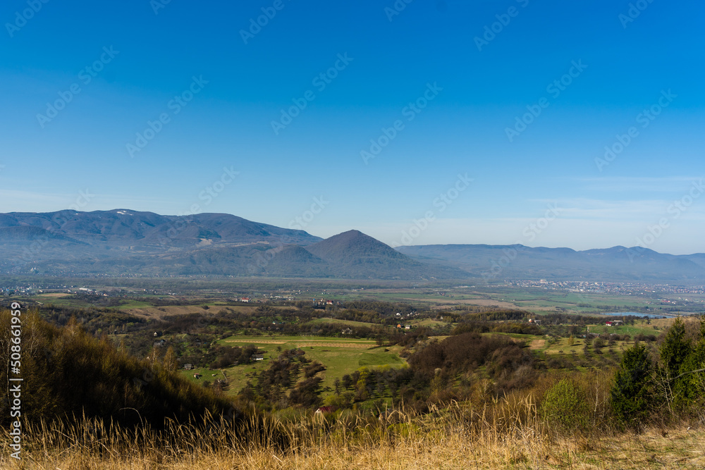 Wonderful view on green hills and mountains. Rural scenery on rolling hills