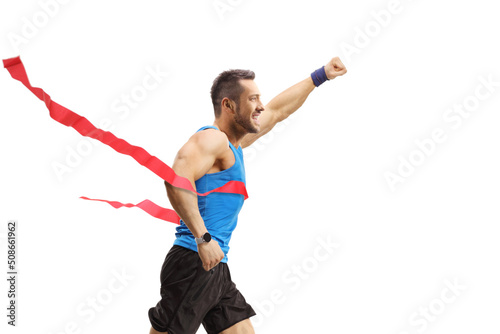 Man on the finish line of a race gesturing happiness