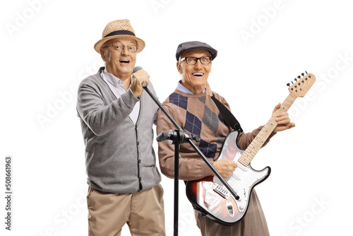 Elderly men playing guitars and singing on a microphone © Ljupco Smokovski