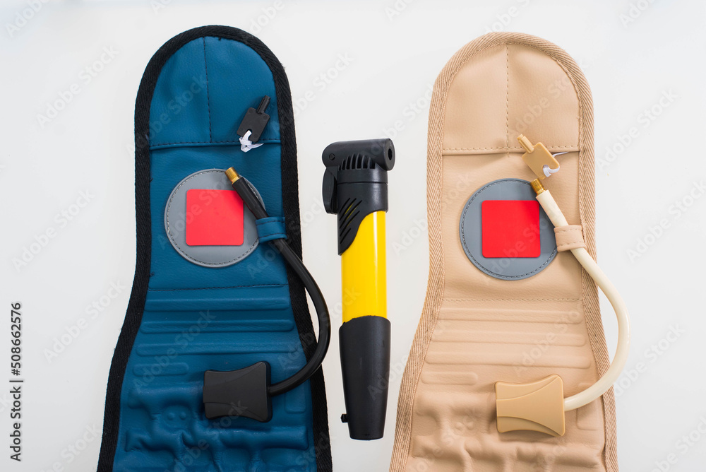 Fototapeta premium pneumocorset and hand pump on a white background