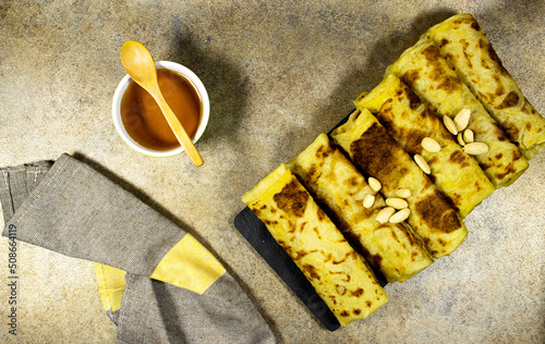 Traditional Handmade Algerian pancakes named rghaif or msemen and almonds with honey bowl  photo