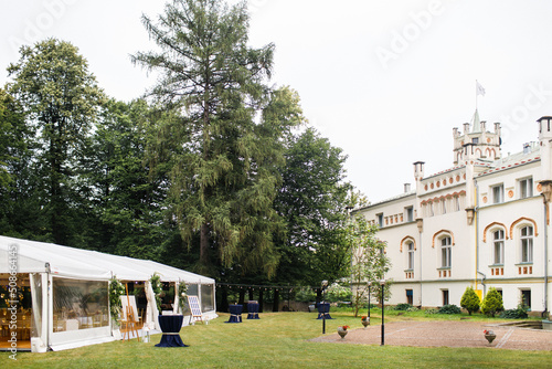 Long white tent for wedding party in the wood