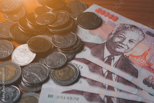 Closeup of lao kip and coin, money and cash concept, inflation situation in lao, orange light