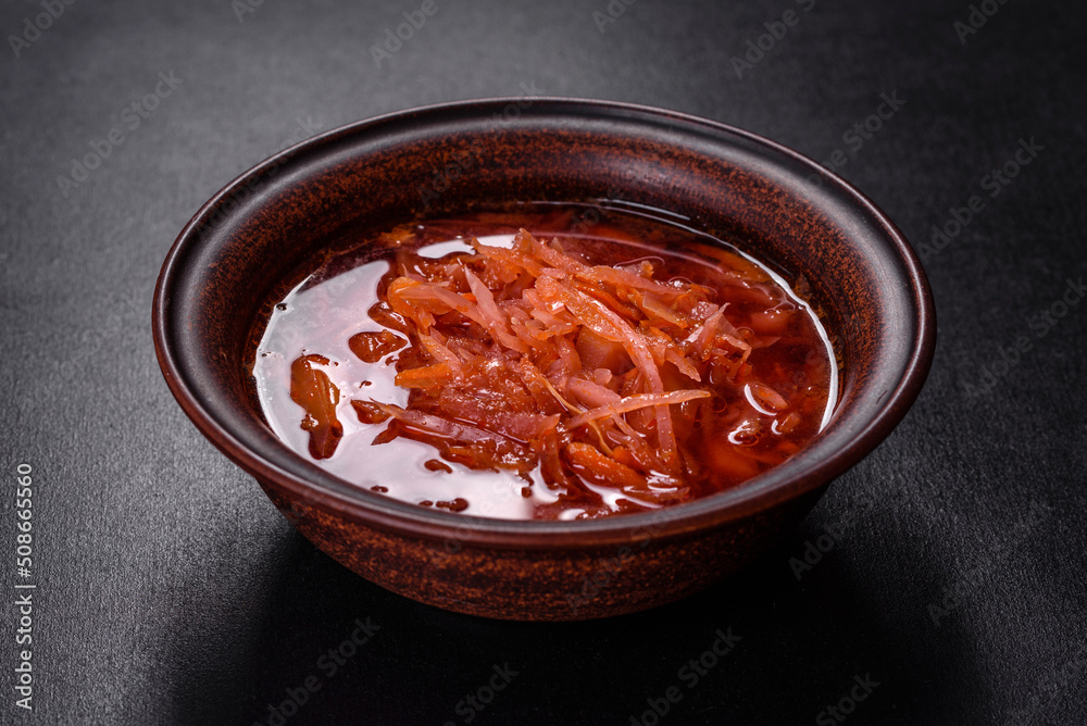 Traditional Ukrainian borscht with beets, tomatoes, garlic, spices and herbs. Ukrainian dish, traditional food Traditional Ukrainian borscht with beets, tomatoes, garlic, spices and herbs. Ukrainian dish, traditional food