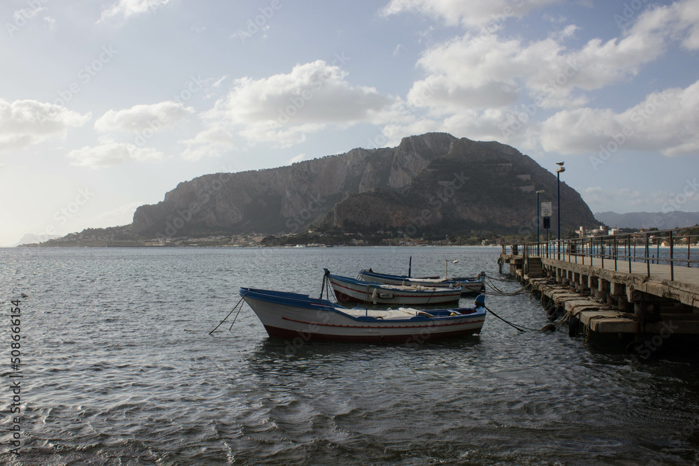 Fototapeta premium evocative image of fishing boats moored in the harbor in a small fishing village in Sicily, Italy 