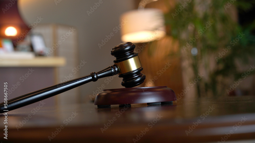 Lawyer or judge's hammer in the court. Auction's hammer is on woo table. Law subject. Lawyer or judge's hammer in the court. Auction's hammer is on woo table. Law subject.