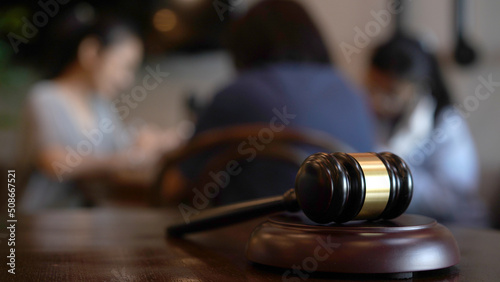 Lawyer or judge's hammer in the court. Auction's hammer is on woo table. Law subject.