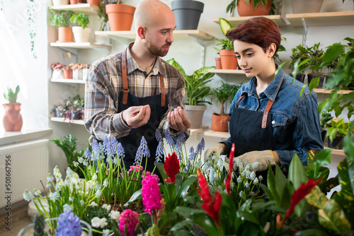 Young florist team at the flower bouquet tying in flower shop