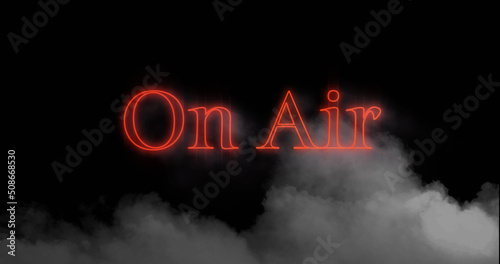 Image of on air neon red text over cloud of smoke on black background