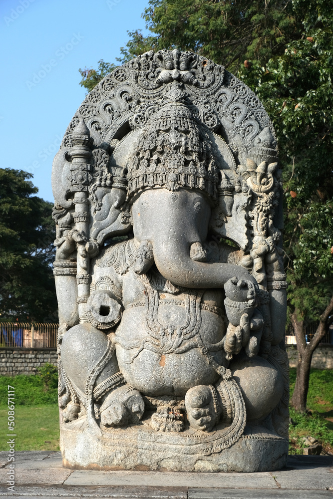 Huge stone Ganesha statue at western entrance of Hoysaleswara temple, Halebidu temple, Halebidu, Hassan District of Karnataka state, India. The temple was built in 12th-century rule of Hoysala Empire.