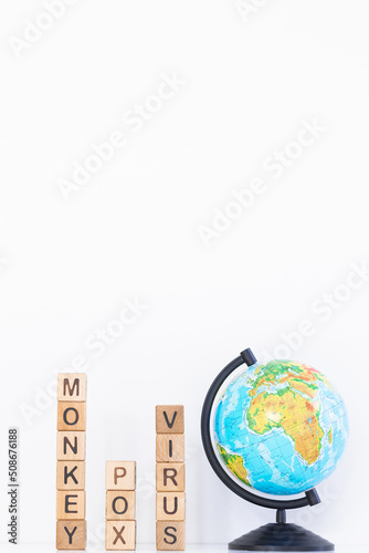 Monkey pox word is written on wooden cubes on a white background. Closeup of wooden elements