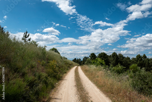 Caminho de terra batida rodeado por monte e um céu nublado em Trás os Montes, Portugal photo