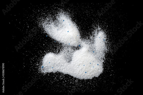 White powder, laundry detergent, washing powder isolated on black, top view photo