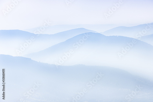 View of distant mountains layers range in morning mist. Meditation and zen landscape.