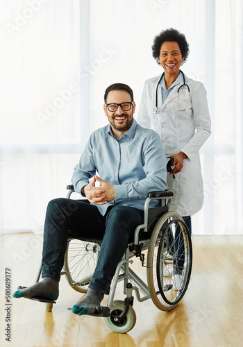 disability wheelchair doctor patient hospital medical disabled man handicap nurse handicapped health young wheel care clinic