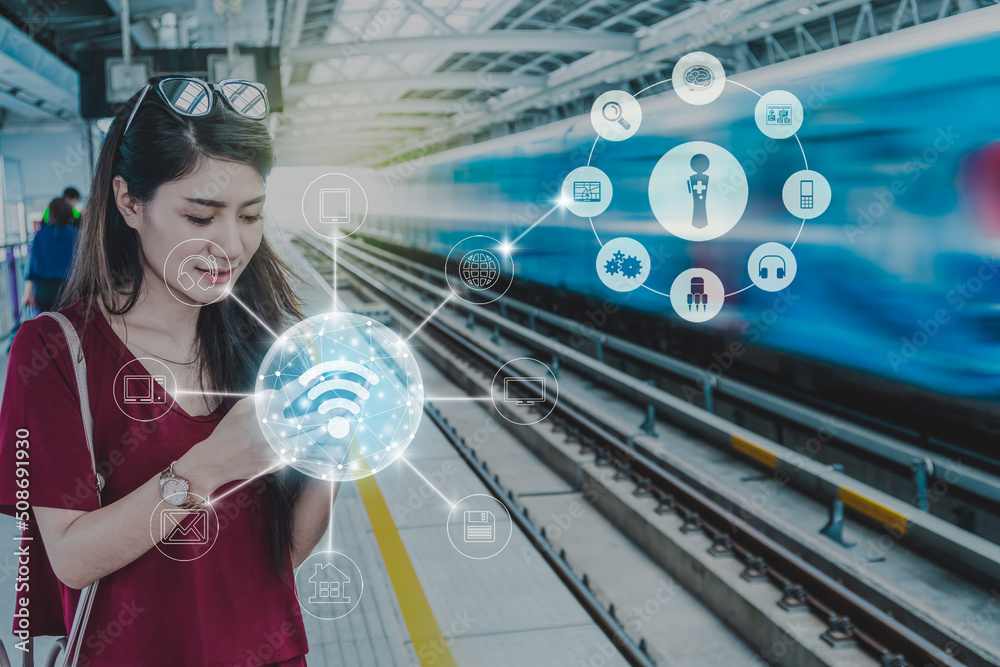 Asian woman passenger with casual suit using the social network via smart mobile phone in the Skytrain rails or MRT subway for online shopping with omni channel, lifestyle and transportation concept
