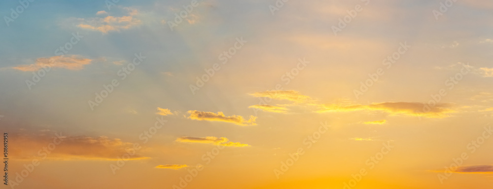 Sky with small clouds at sunset in soft pastel colors
