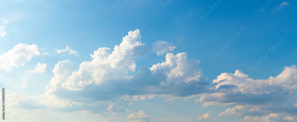 White curly clouds in the blue sky in sunny weather - obrazy, fototapety, plakaty 